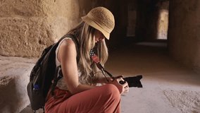 Blonde tourist woman taking a photo in Ancient Jerash ruins, Jordan