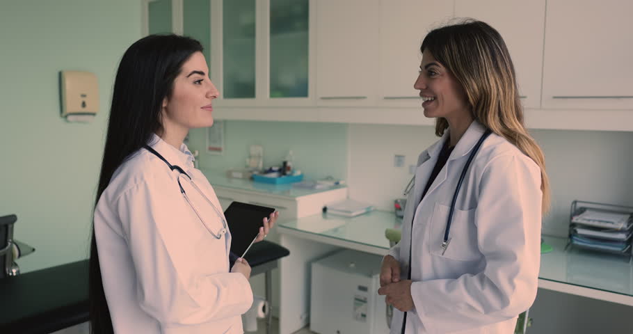 After conversation two pretty Latina women colleagues physicians shaking hands, express mutual respect for effective collaboration, shared commitment to patient care. Teamwork, partnership, medicine Royalty-Free Stock Footage #3470279465