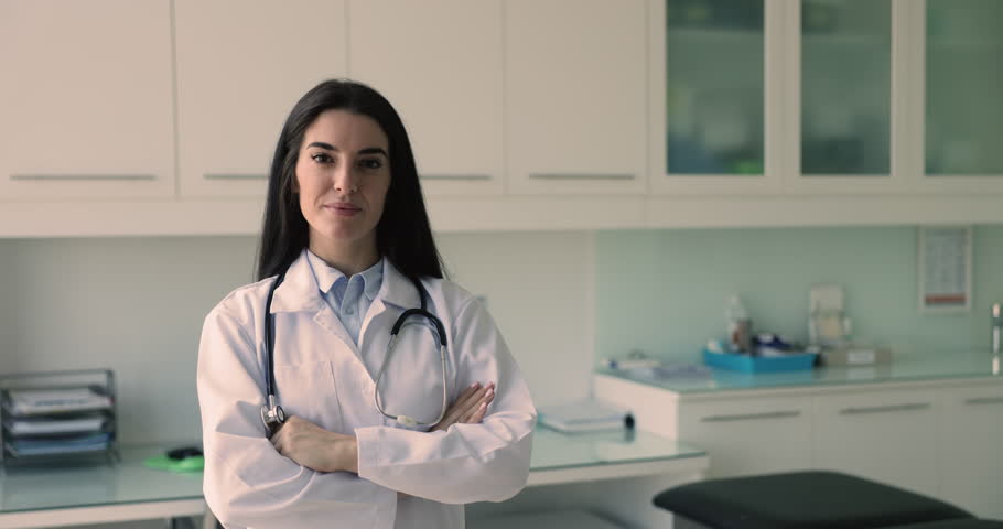 Happy Latina general practitioner, nurse or cardiologist pose in office. Professional medical worker, met standards of knowledge, skills, and experience in their field. Board-certified doctor portrait Royalty-Free Stock Footage #3470280841