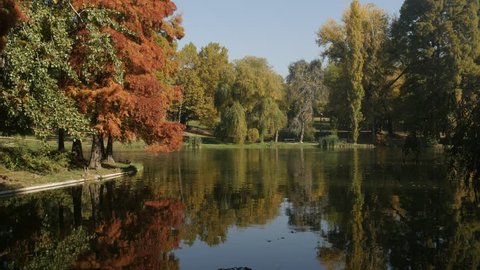 Colorful nature by the autumn in Craiova 3840X2160 UltraHD footage - Pond water reflections in the park 4K 2160p 30fps UHD tilting video