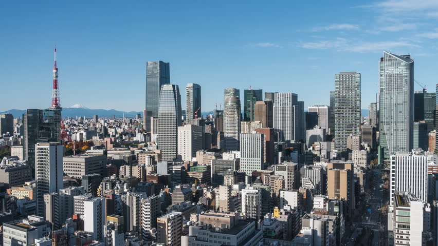 Timelapse view of skyscrapers in Minato City on a sunny day in Tokyo, Japan, zoom out. 