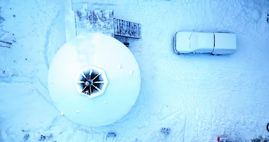 Aerial Top Upward Shot Of Snow Covered Yurt And Car In Tranquil Forest During Winter Season - Fairbanks, Alaska