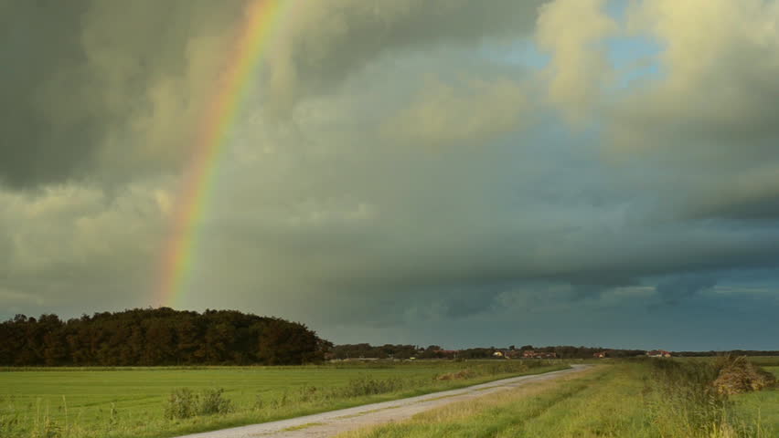 rainbow over rural Dutch landscape