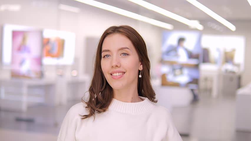 Portrait of a Gorgeous Dark Haired Woman Smiling Charmingly while Standing in the Middle of Modern mall. Happy Young Woman Enjoys Life 4K Royalty-Free Stock Footage #3470607991