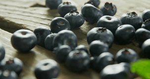 Animation of 100 percent organic text over blueberries. Food and ecology concept digitally generated video.