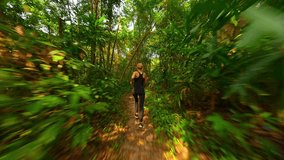 Caucasian woman runs in tropical rainforest in Thailand - Powered by Shutterstock - Get 15% off with code: PIKWIZARD15