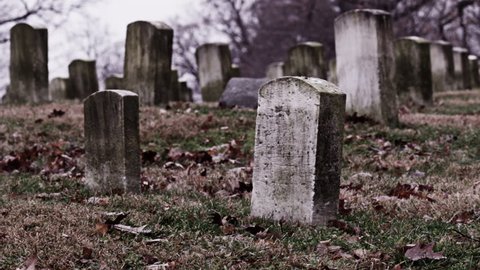 Old, weathered gravestones at a cemetery (Dolly Move two directions)