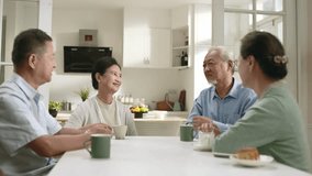 two happy senior asian couples sitting at table at home having a pleasant conversation - Powered by Shutterstock - Get 15% off with code: PIKWIZARD15