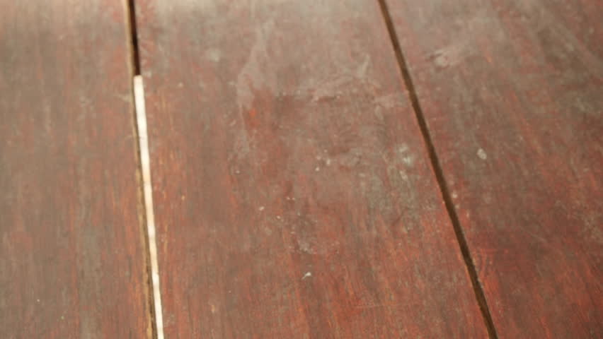 Chocolate cake decorated with almonds on plate close-up top view.