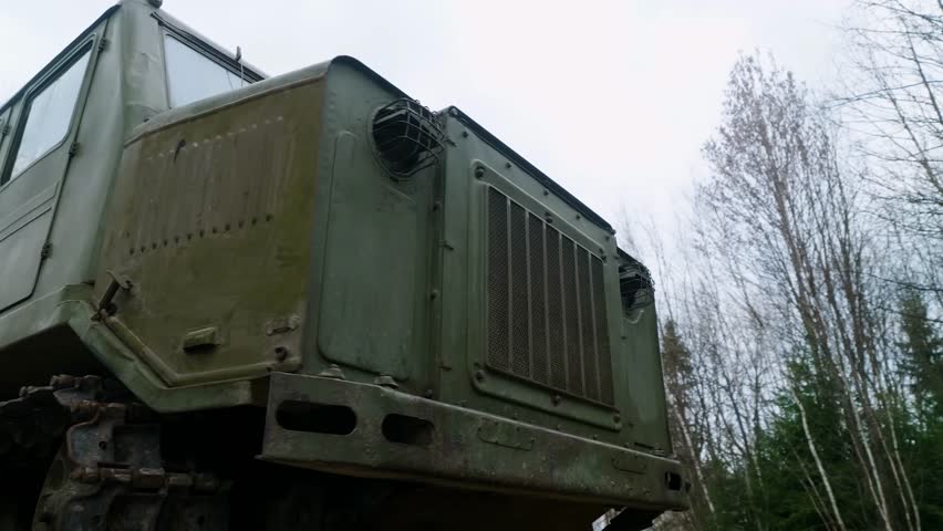 The exterior of a mid-20th century medium-track artillery tractor, designed for towing trailers, transporting people, and cargo.