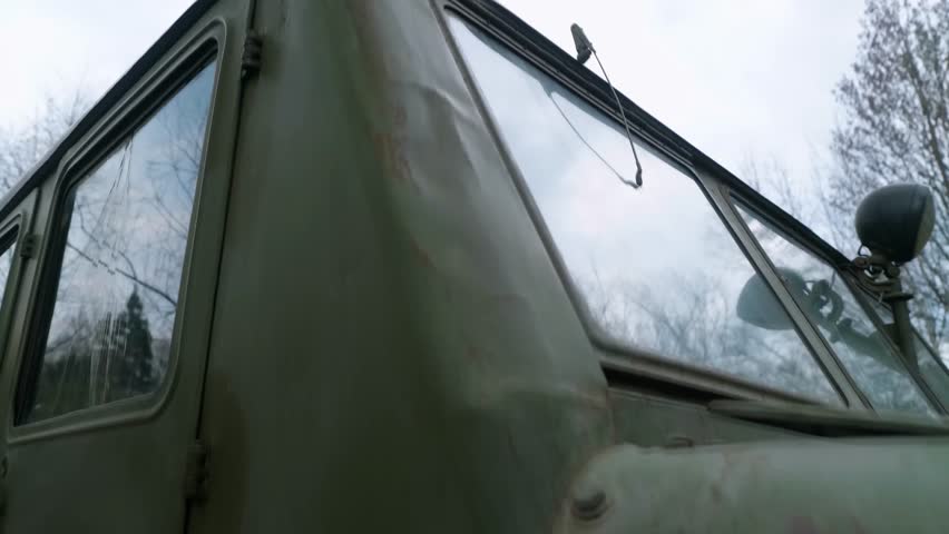 The exterior of a mid-20th century medium-track artillery tractor, designed for towing trailers, transporting people, and cargo.