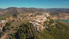 Aerial 4K video from drone to town Iznajar on a sunny summer day. Cordova, Andalusia, Spain

