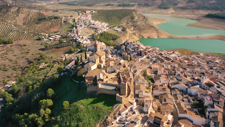 Aerial 4K video from drone to town Iznajar on a sunny summer day. Cordova, Andalusia, Spain

