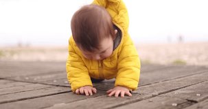 adorable video capturing the pure joy of a little boy, less than one year old, as he crawls towards the camera, giggling with sheer delight