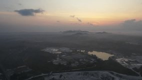 View of Sand dunes, Blue Lake in Belitung district, Indonesia. The video was taken using a drone, and was taken when the sun had just risen. This beautiful view from an angle from above is very rare f