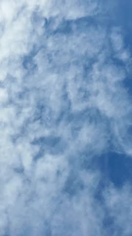 Running clouds on blue sky, vertical video Royalty-Free Stock Footage #3471393135