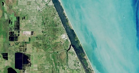 Very high-altitude overflight aerial of coastal land and water, Brevard County Florida. Clip loops and is reversible. Elements of this image furnished by NASA