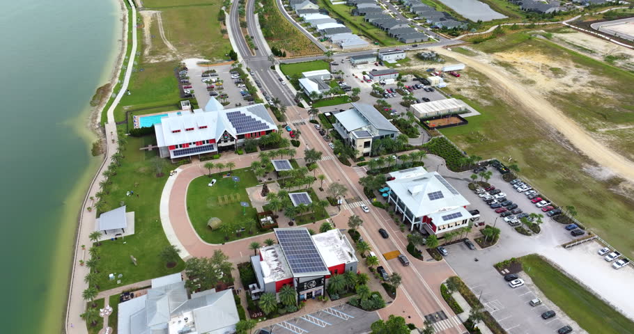 Solar photovoltaic panels installed on top of Florida office buildings for producing clean ecological electric energy. Renewable electricity with zero emission concept.