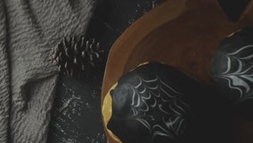 Spiderweb bread with dark chocolate. Sweet bread. decorated A white and dark chocolate. The cake is on a dark wooden table with A cup of tea. With dark background  - Powered by Shutterstock - Get 15% off with code: PIKWIZARD15