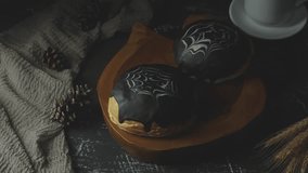 Spiderweb bread with dark chocolate. Sweet bread. decorated A white and dark chocolate. The cake is on a dark wooden table with A cup of tea. With dark background  - Powered by Shutterstock - Get 15% off with code: PIKWIZARD15