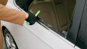 Man diligently remove shattered glass remnants from broken rear car window after crime using brush. Man meticulously removes glass remnants with brush Clean up crime scene man brushes away glass. - Powered by Shutterstock - Get 15% off with code: PIKWIZARD15