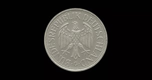 Obverse of Germany coin 1 mark 1990, isolated in black background. Loopable animation in 4k resolution video.