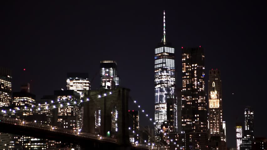 Slow motion of New York City skylines and Brooklyn Bridge at night