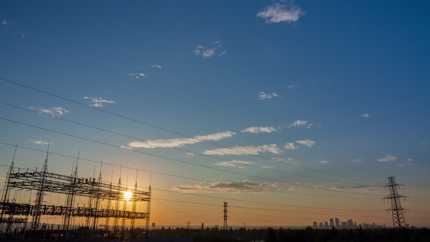 Silhouetted electricity at sunrise time colorful sky background. time lapse of sun rise in the morning created clean energy for a city utility. an organization supplying the community gas and energy Royalty-Free Stock Footage #3471697181