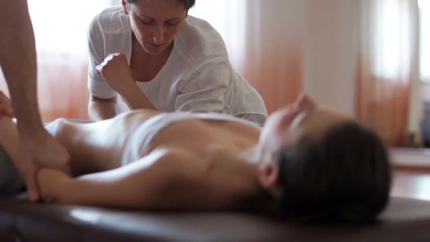 Two therapists doing massage of hands  in spa
