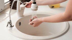 woman washes fresh blueberries under running water in a colander for lemonade.Close-up. - Powered by Shutterstock - Get 15% off with code: PIKWIZARD15