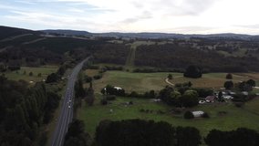 Drone descending showing a major rural road in Australia with a farm in the background