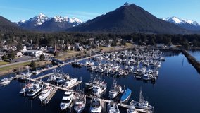 4k 23.98fps aerial video of beautiful downtown Sitka, Alaska, and the small boat harbor. Captured March 2024.