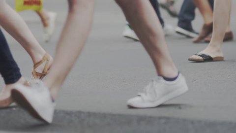 Slow Motion Shot Of People's Feet Crossing A Street In Berlin In Summer.