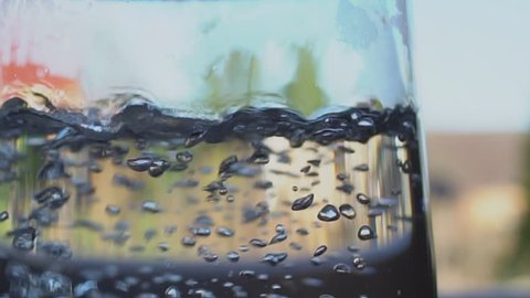 Slow Motion Shot Of Water Boiling In A Glass Kettle In A Farm House Kitchen.