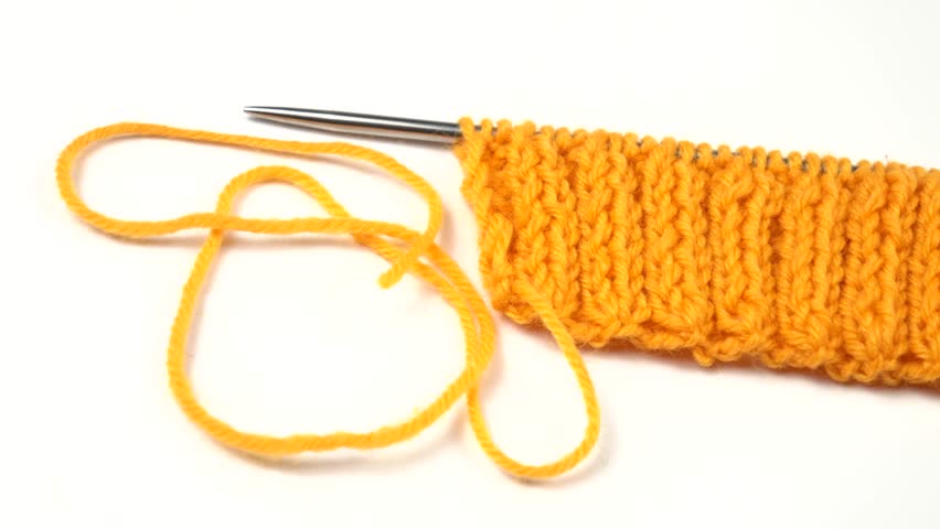 Ball of orange color threads for knitting,  knitting pattern sample rib stitch,  and knitting needles are on a white table Royalty-Free Stock Footage #3471790661
