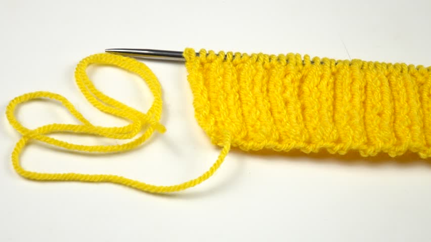 Ball of yellow threads for knitting, knitting pattern sample rib stitch, and knitting needles are on a white table Royalty-Free Stock Footage #3471791081