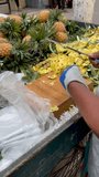 cutting and selling fresh pineapple slices on street fruit stall in Chittagong.this 4k video was taken from Chittagong,Bangladesh.