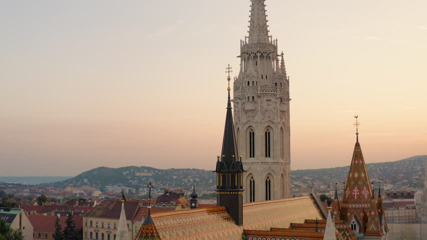 Close-up view of the renovated towers of Matthias Church with colored Zsolnay roof tiles. Baroque-style Catholic church bell towers with holy crosses on top. Buda Castle, Budapest, Hungary, Buda Hills