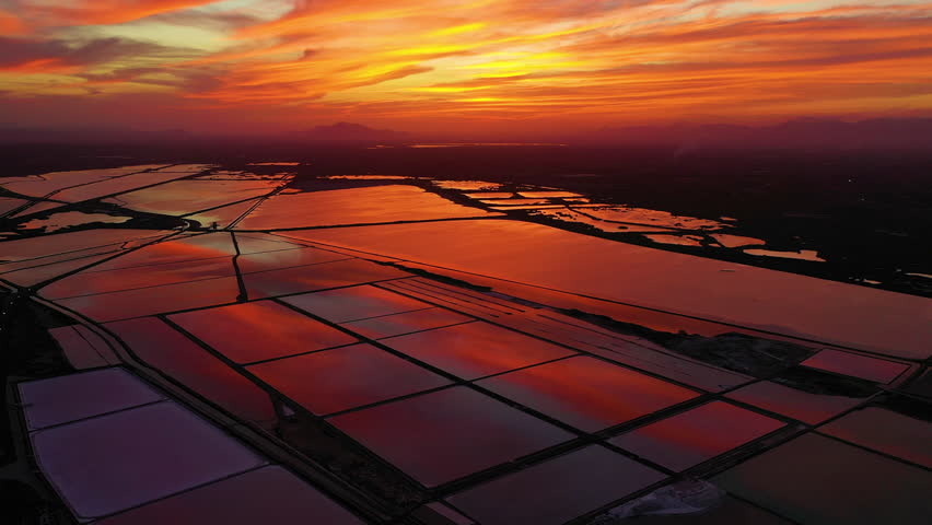 Spectacular aerial view at sunset in the Santapola Salt Flats, over the sea water lagoons, with the city of Santapola in sight, Spain.