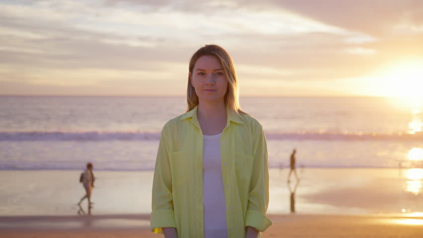 Attractive young female using futuristic augmented reality software interface standing outdoors at ocean beach. Woman wearing headset to look at VFX Animation with futuristic project at scenic sunset Royalty-Free Stock Footage #3471878931