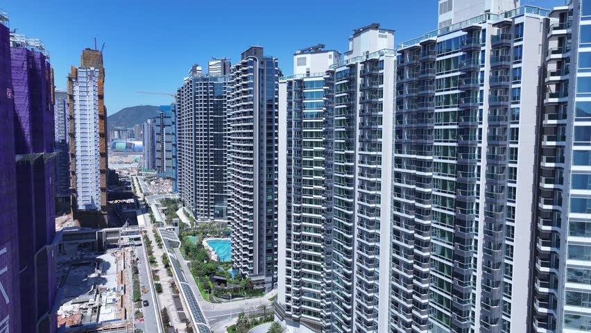 Seaside commercial residential construction project in Kai Tak Sports Park Cruise Terminal Hong Kong, Kwun Tong and Kowloon Bay near Victoria harbour, Aerial drone skyview