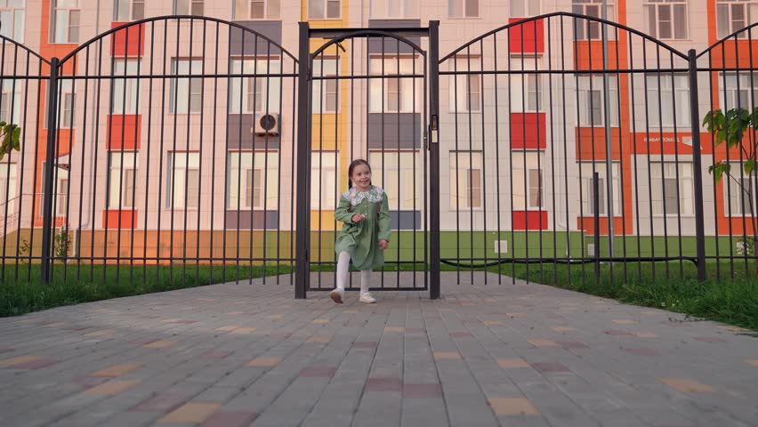 happy man father parent circling child daughter arms. happy family children dream. father meets child from school. child runs against backdrop school building his parents father. man girl happy face.