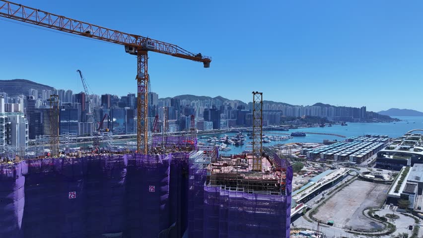 Seaside commercial residential construction project in Kai Tak Sports Park Cruise Terminal Hong Kong, Kwun Tong and Kowloon Bay near Victoria harbour, Aerial drone skyview