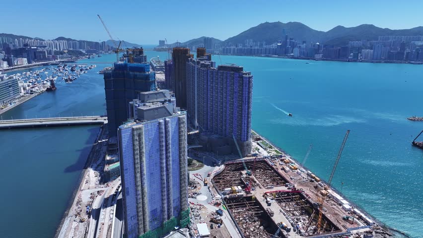 Seaside commercial residential construction project in Kai Tak Sports Park Cruise Terminal Hong Kong, Kwun Tong and Kowloon Bay near Victoria harbour, Aerial drone skyview
