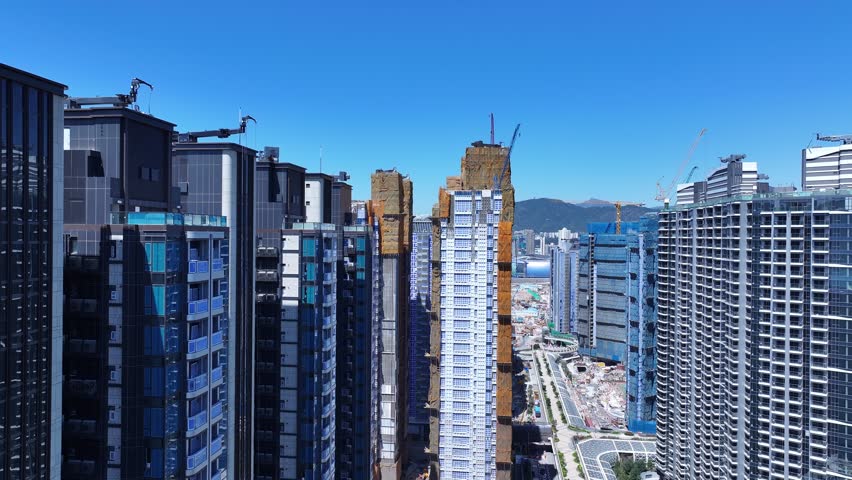 Seaside commercial residential construction project in Kai Tak Sports Park Cruise Terminal Hong Kong, Kwun Tong and Kowloon Bay near Victoria harbour, Aerial drone skyview