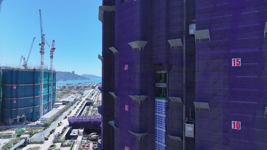 Seaside commercial residential construction project in Kai Tak Sports Park Cruise Terminal Hong Kong, Kwun Tong and Kowloon Bay near Victoria harbour, Aerial drone skyview