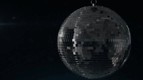 Animation of spinning disco ball over black background. Party and celebration concept digitally generated video.