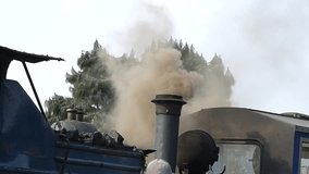 black smoke emitting from Unesco heritage labelled steam engine in Darjeeling in India