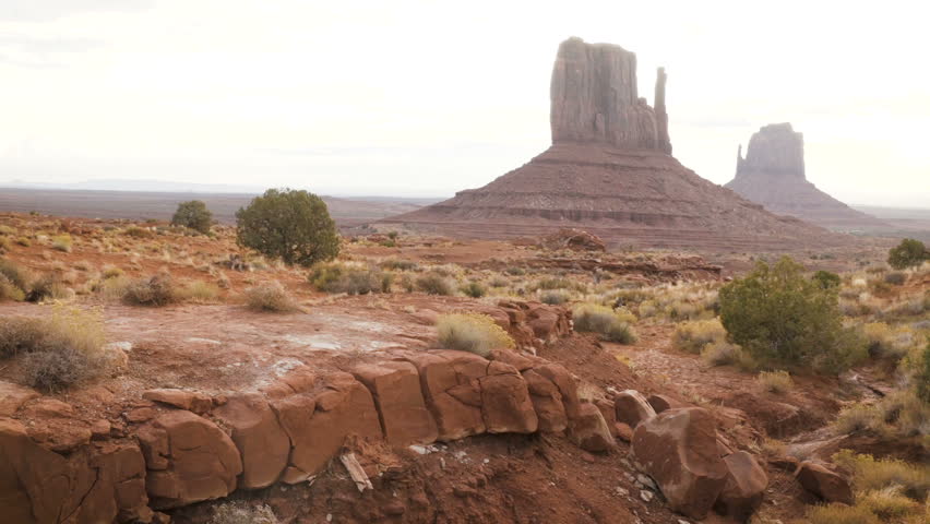 woman walking in Monument Valley with red rocks overview. Arizona