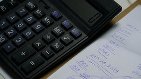 Person Calculating Budget on Electronic Calculator With Handwritten Notes in Office Environment - Powered by Shutterstock - Get 15% off with code: PIKWIZARD15